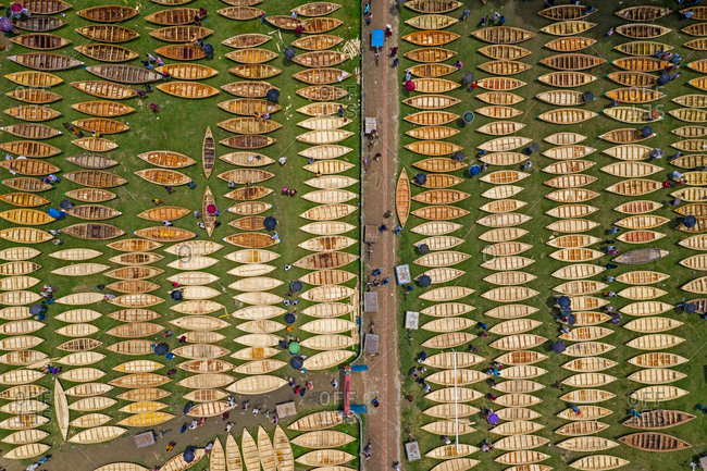 Aerial view of hundreds of small wooden boats are lined up for sale at the largest traditional boat market in Manikganj, Bangladesh.