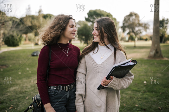 Portrait of two female friends students on college campus
