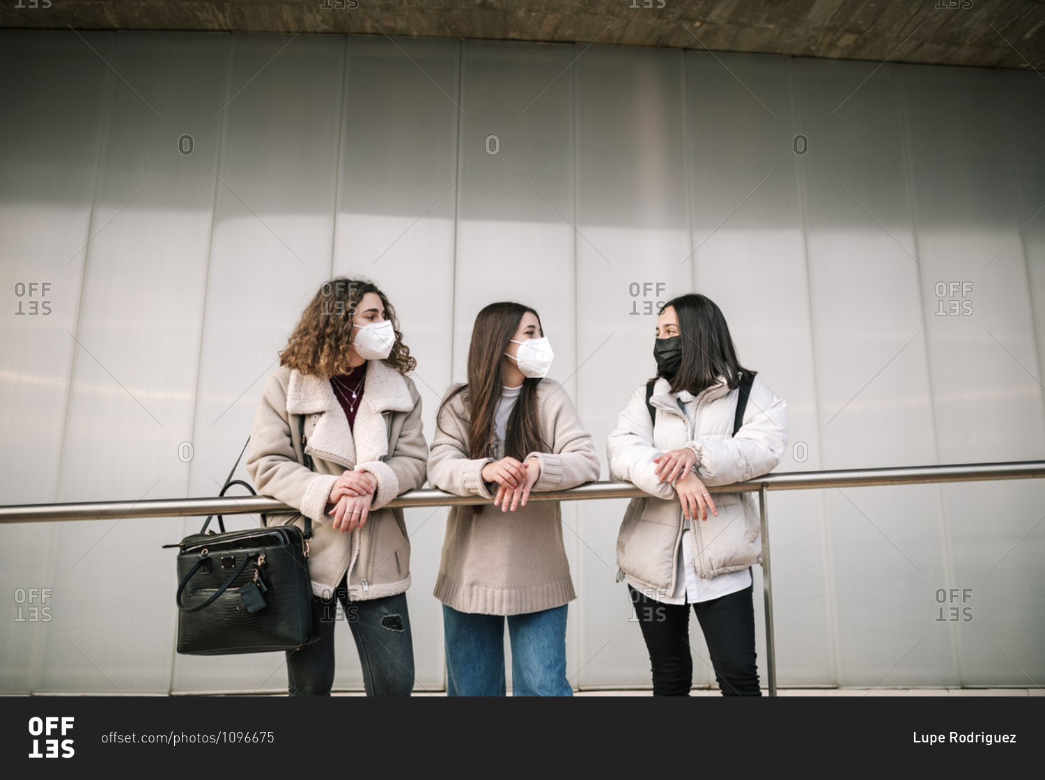 Three female college friends with masks at college