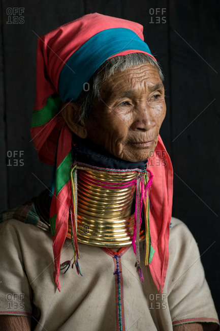PADUANG PEOPLE, PAN PET VILLAGE, KAYAH STATE, MYANMAR - 20 January 2020: Portrait of Kayan mother and child wearing brass coils placed around the neck, appearing to lengthen it, sat in window light.