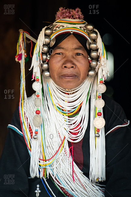 AKHA HILL TRIBE, HOKYIN VILLAGE, MYANMAR - 22 January 2019: Close up portrait of hill tribe women in traditional dress and decorated head dress including fresh flowers.
