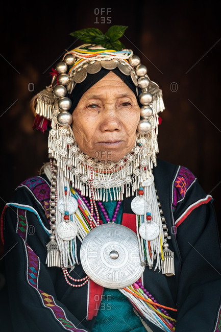 AKHA HILL TRIBE, HOKYIN VILLAGE, MYANMAR - 22 January 2019: Close up portrait of elderly hill tribe women in traditional dress and decorated head dress.
