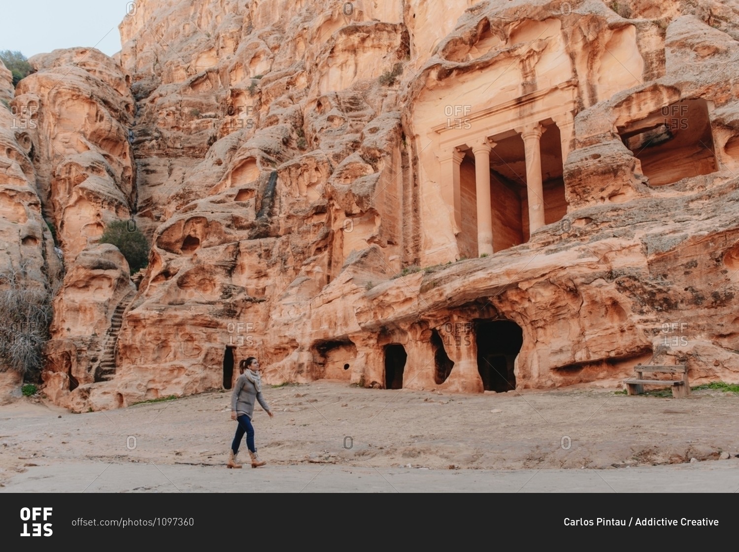 Side view of female tourist walking near ancient The Treasury temple during vacation in Petra