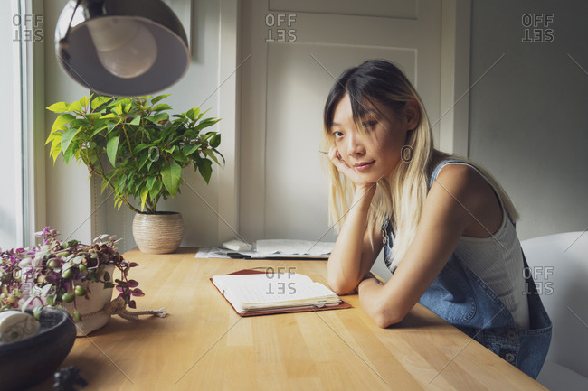 Premium Photo  Pensive woman sitting at table while thinking