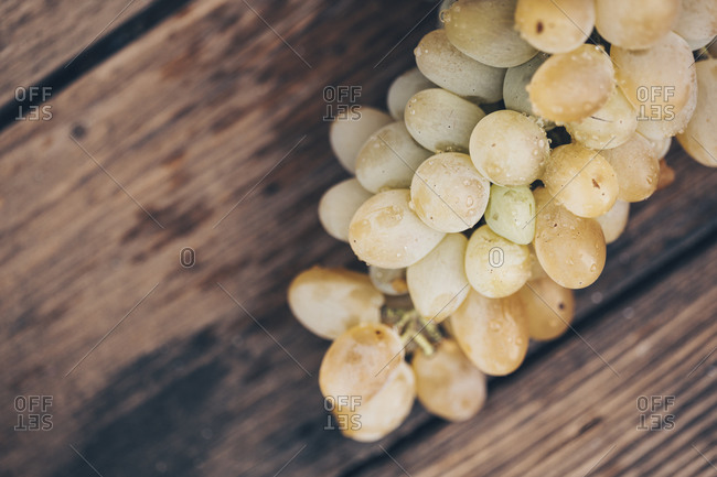 Bunch of white grapes on a wooden background