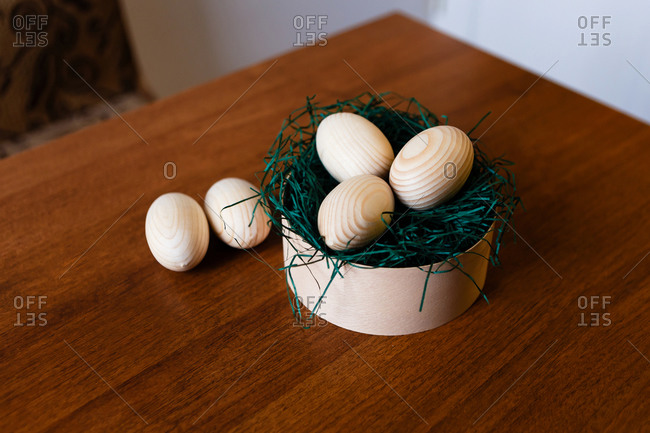 Close up of wooden Easter eggs in a wooden box on table