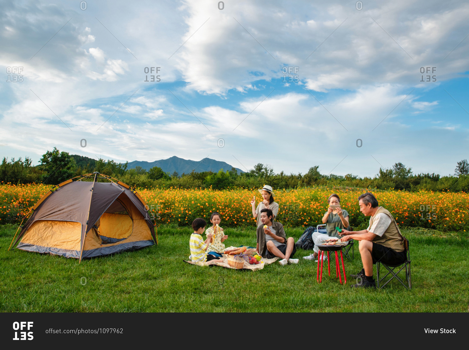 Happy family enjoying a picnic together on a camping trip in the