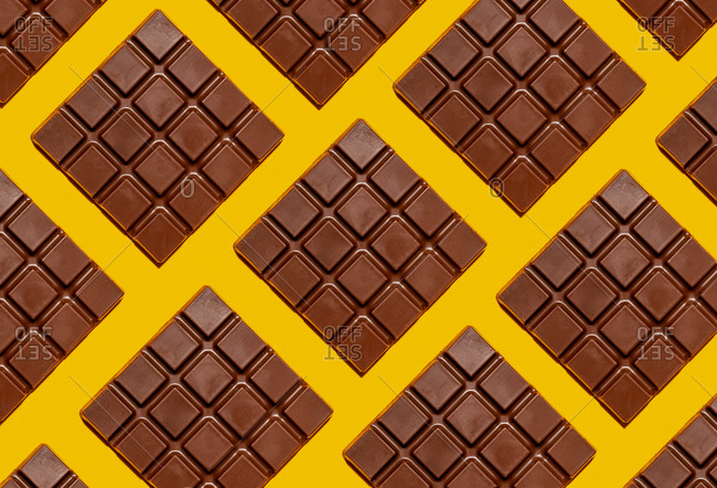 Pattern of chocolate bars against yellow background