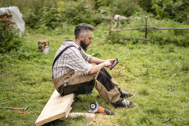 Carpenter using digital tablet during break