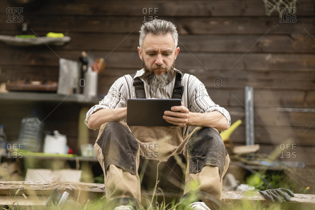 Portrait of carpenter using digital tablet during break