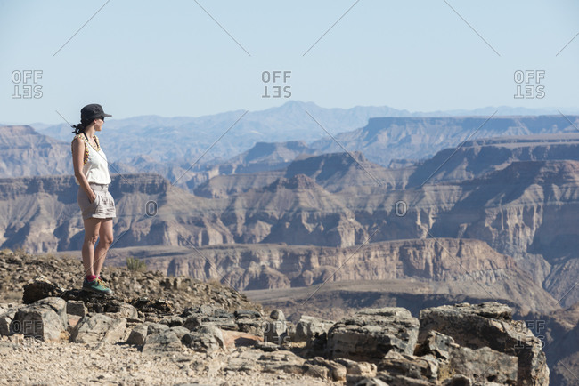 A woman stands on the edge of the Fish River Canyon in Namibia