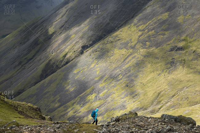 Descending on a scree slope from the top of Great Gable in English Lake District in Wast Water
