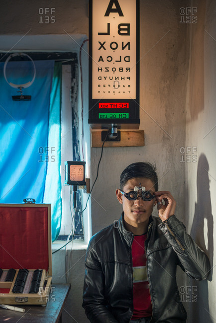 A optician or optometrist tests a patients eyesight in a small hospital in Nepal