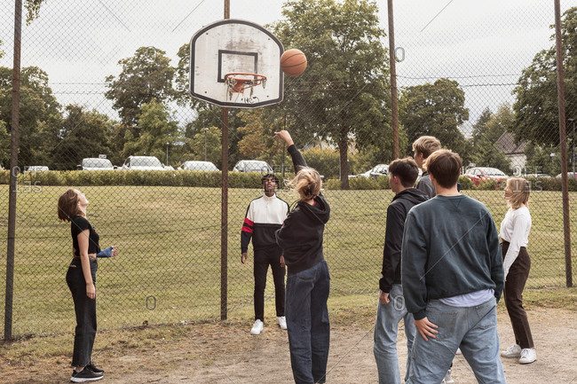 Teenagers playing basketball - Offset Collection
