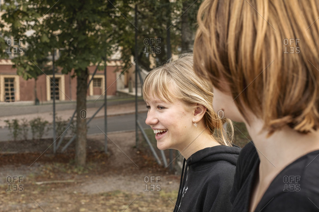 Smiling teenage girls talking - Offset Collection