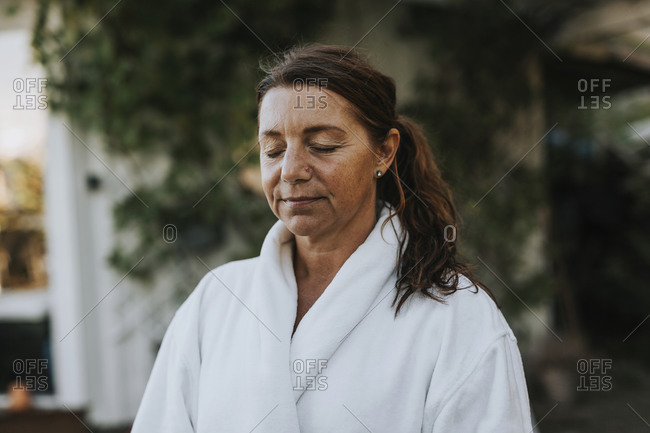 Mature woman with eyes closed
