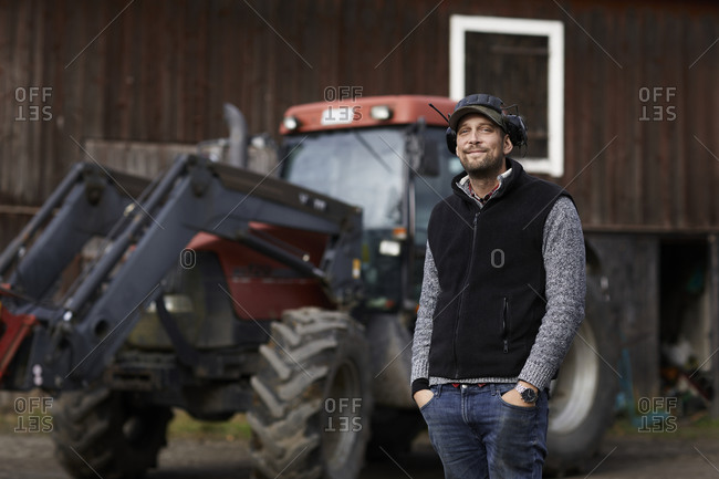 Farmer standing next to tractor
