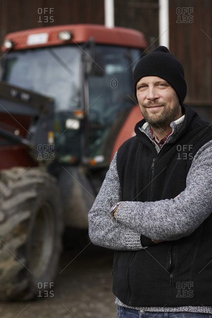 Farmer standing next to tractor