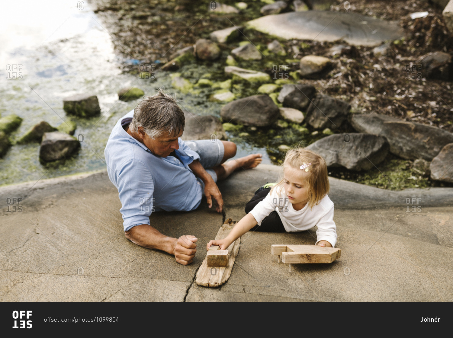 Father and daughter sitting at sea