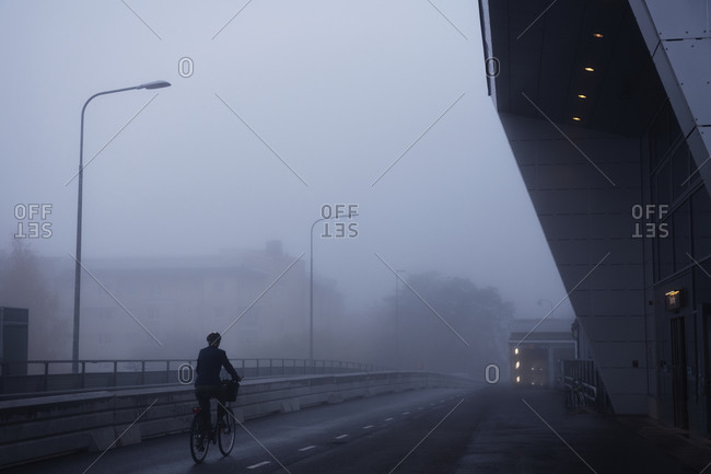 silhouette of cyclist in foggy weather
