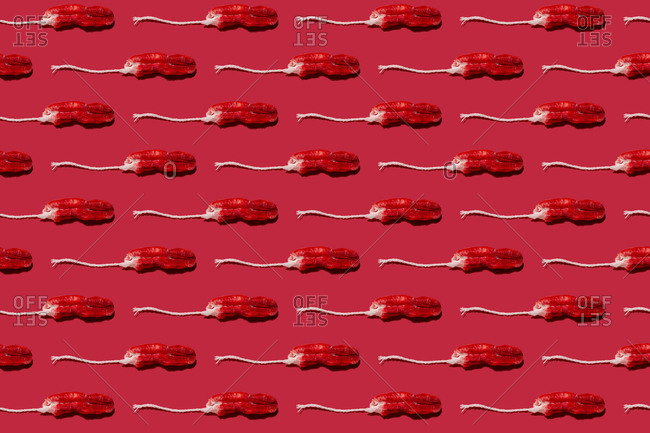 Pattern of used tampons against red background