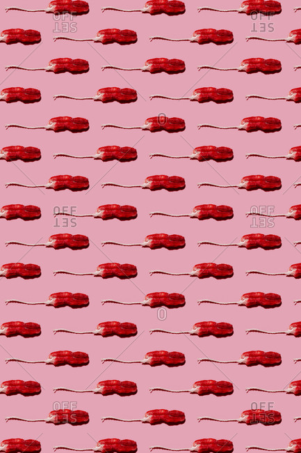 Pattern of used tampons against pink background