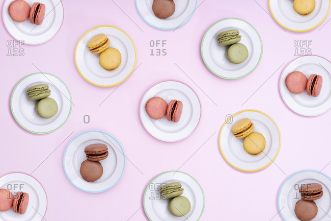 Pattern of plates with colorful macaroon cookies