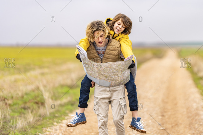 Young girl carrying sister giving piggyback ride Stock Photo