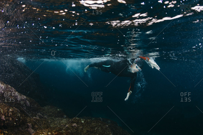 Underwater view of man diving in sea