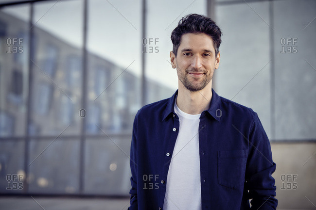 Entrepreneur smiling while standing outdoors