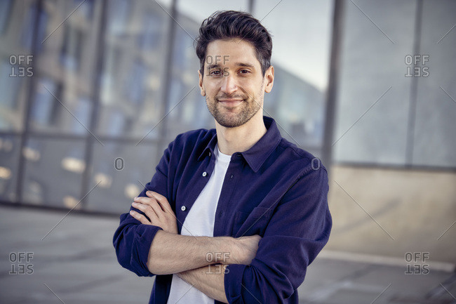 Male entrepreneur standing with arms crossed outdoors