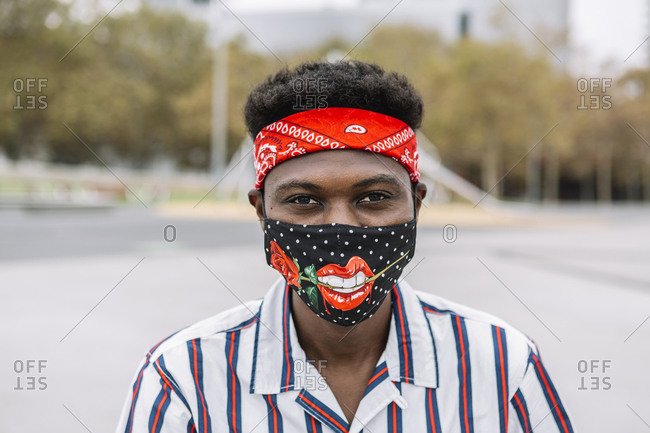 Mid adult man wearing sensual face mask outdoors