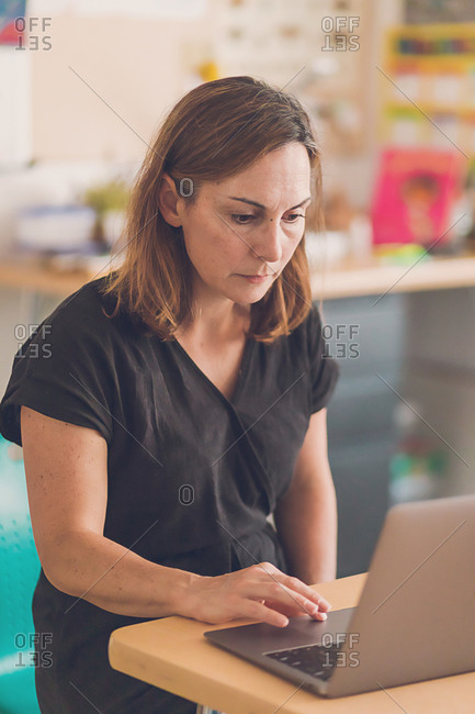 Elementary School teacher working on her laptop.