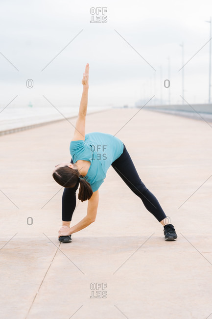 Balancing in Extended Triangle Pose Stock Photo by Media_photos | PhotoDune