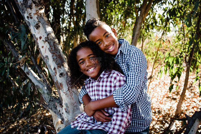 Brothers Embracing & Smiling for Camera at Park in Chula Vista