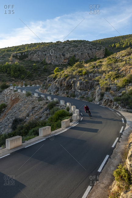 Man riding a bicycle on the mountain road from Benissa to Pinos.