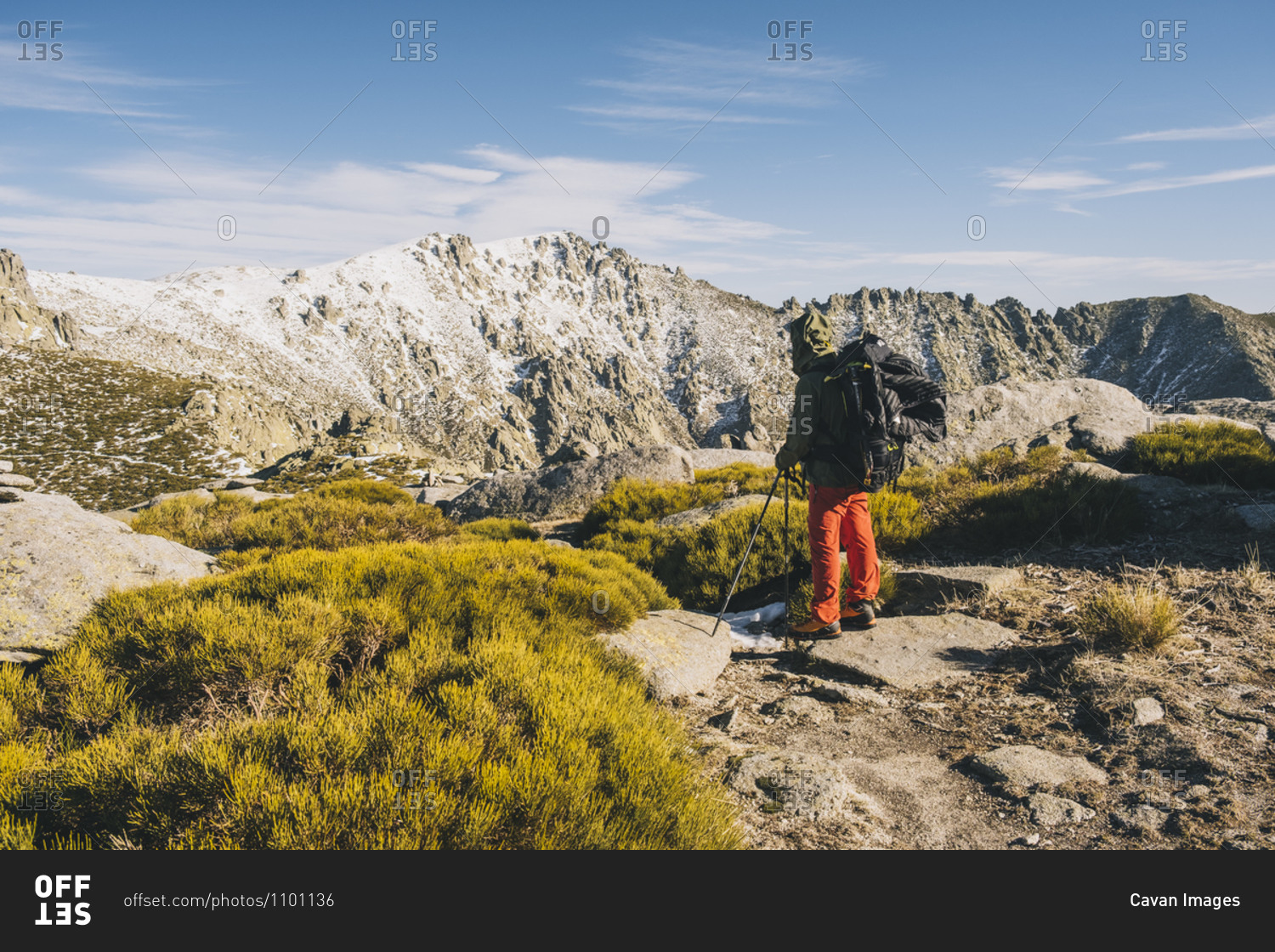 Young man looking at his objective summit during hike stop, Gredos, Avila, Spain