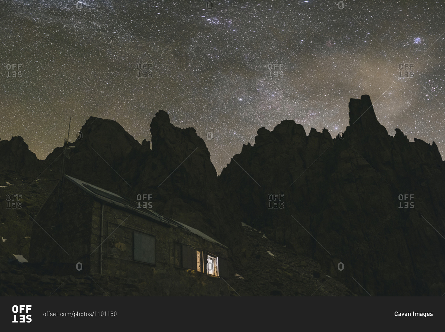 Galayos refuge against granite spikes and Milky Way during a winter night, Gredos, Spain