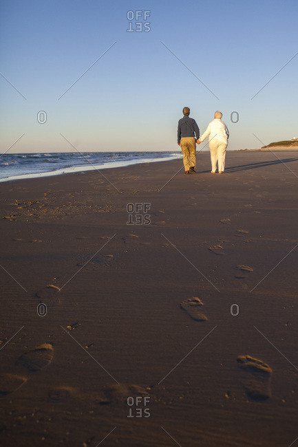 Married couple in their Seventies showing affection at Cold Storage Beach on Cape Cod
