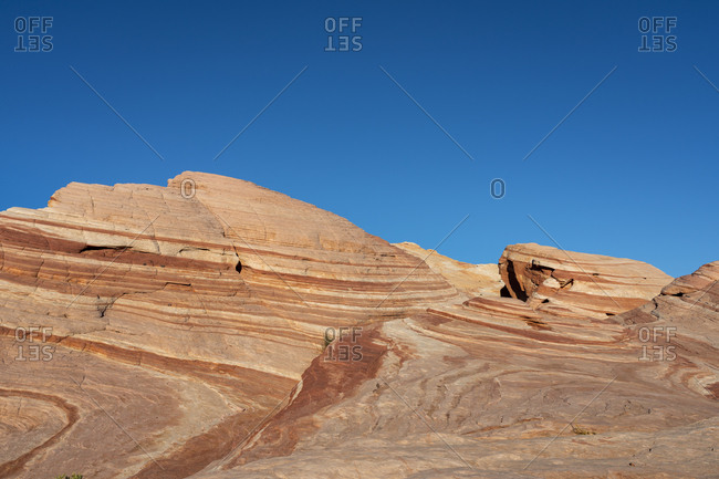 Red rock formations at Fire Wave against blue clear sky, Valley of Fire State Park, Nevada, USA