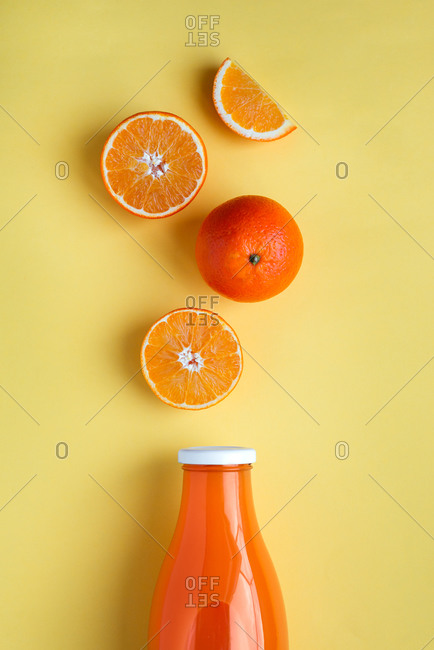 Freshly squeezed orange juice on yellow background