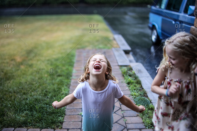 little girl screaming in the rain in spring