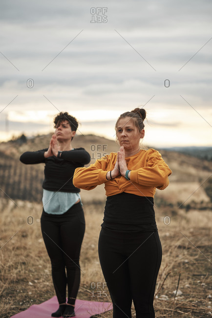 2 young women practicing pilates in the countryside