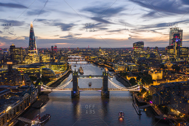 Aerial view of London bridge crossing the river Thames at sunset, United Kingdom.