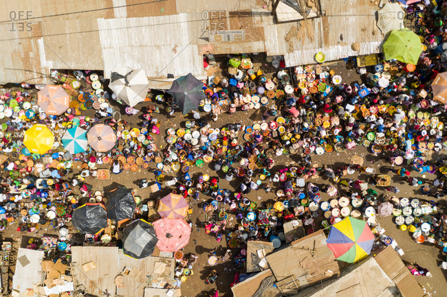 Aerial view of traditional city market with people in Tombo city, Western Area, Sierra Leone.