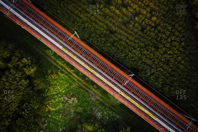 Aerial view of train rail road crossing the countryside near Flaca township, Girona, Spain.