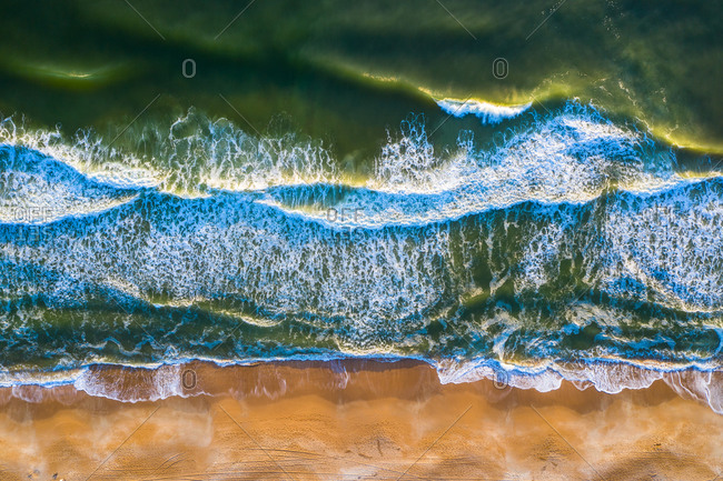 Aerial view of crispy waves of North Atlantic Ocean breaking on the sandy beach of Anastasia Island in Florida, United States of America