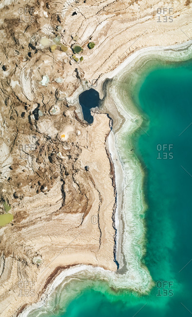Aerial view of colorful sinkholes at the shores of the dead sea, Jordan Rift Valley, Israel.