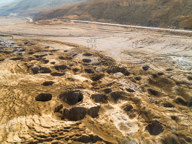 Aerial view the sinkholes phenomena and the destruction it caused at the shore near the dead sea. Jordan Rift Valley, Israel.