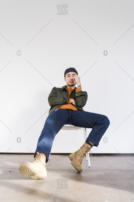 A Young Handsome Male Sitting On Chair And Posing Isolated On White  Background Stock Photo, Picture and Royalty Free Image. Image 13516488.